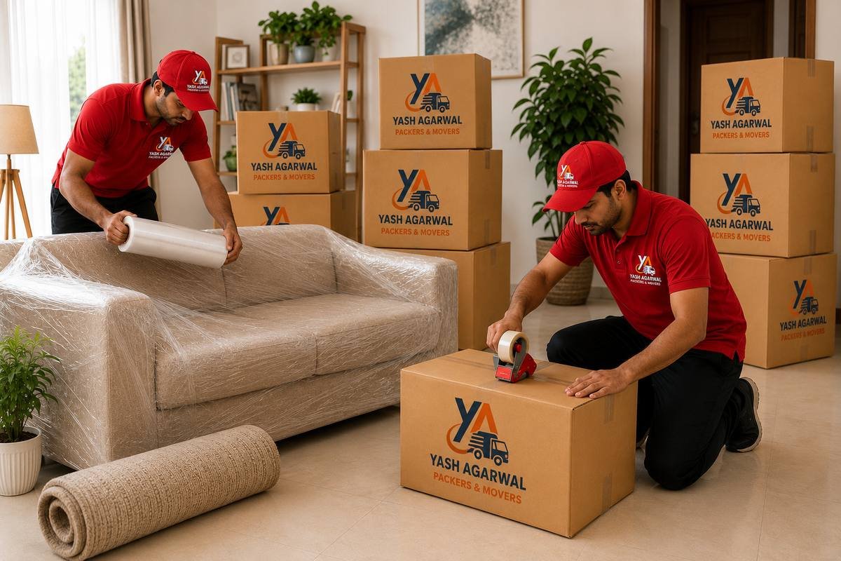 Movers wrapping a sofa and packing boxes during a household shifting